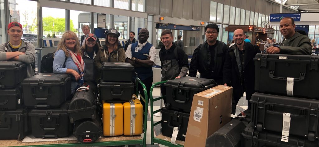 The Girl Who Wore Freedom crew at the airport with all of the gear