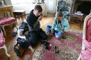 Savannah and Jason Hoban testing audio equipment before interviewing a French civilian about the occupation and liberation