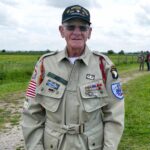 Staff Sergeant Rice of the 101st Airborne standing in front of the reenactors