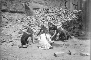Kids playing in rubble after bombing.
