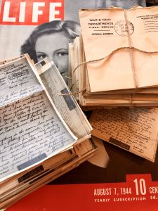 Stack of letters labeled v-mail with an issue of LIFE magazine dated Aug 7th 1944