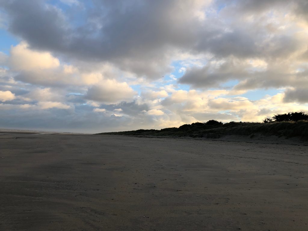A beach in Normandy with beautiful clouds